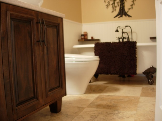 Simple powder room vanity in knotty alder with wooden legs and custom distressed finish.